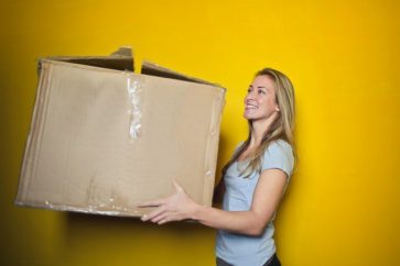 woman-in-grey-shirt-holding-brown-cardboard-box-761999